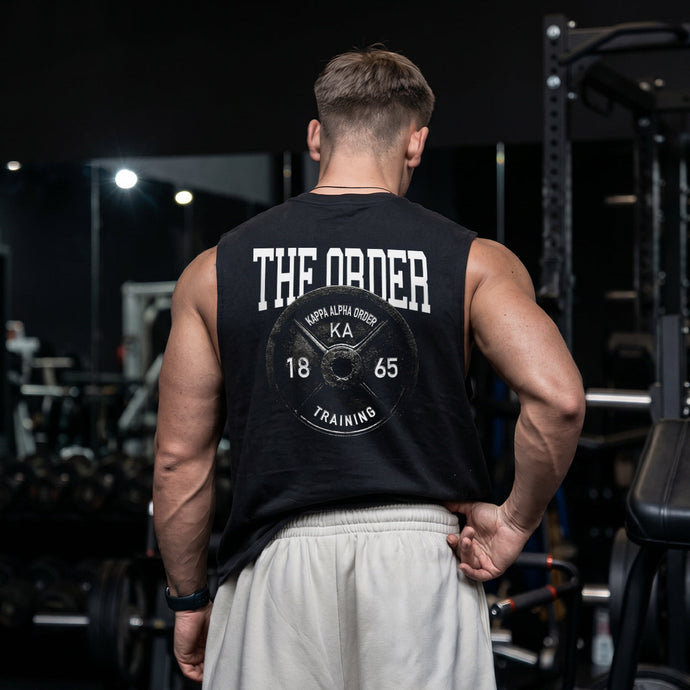 Man wearing a black cut off tank with premium grunge gym design