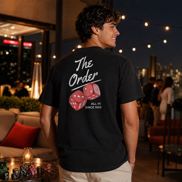 Comfort Colors High Roller Tee shown front and back, featuring a small dice graphic on the chest pocket and a large casino-inspired dice design on the back.