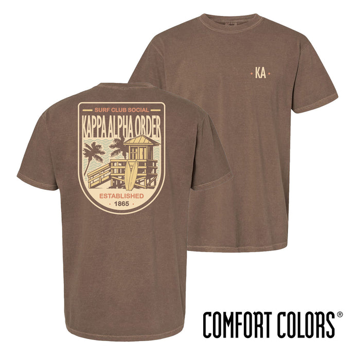Brown Comfort Colors Surf Club Social T-shirt featuring a small front logo and a large surf club back graphic.