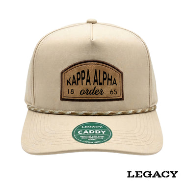Cream Legacy brand rope hat featuring a brown fraternity patch, designed for stylish fraternity apparel and casual campus wear.