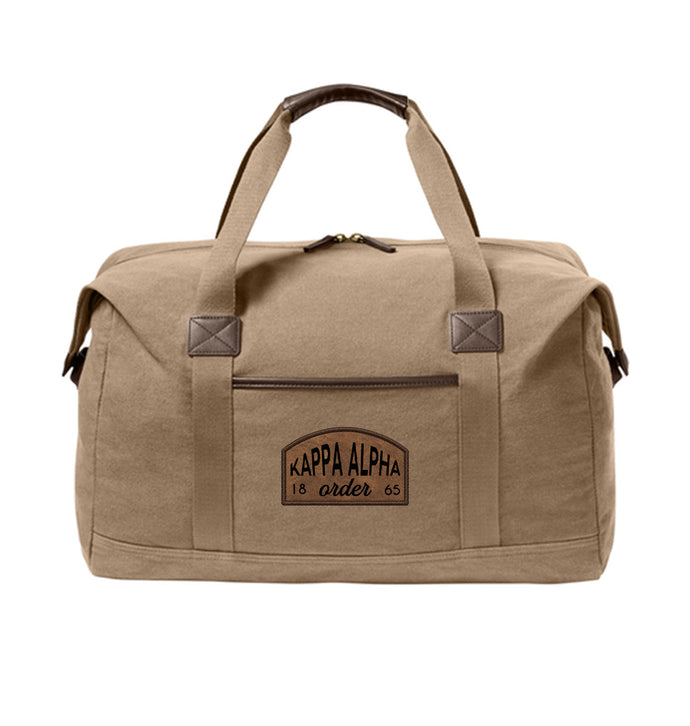 Fraternity Tan Canvas Duffel Bag with leather patch on front.